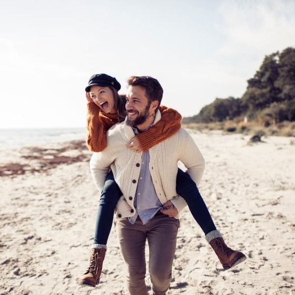 Couple Walking Along Beach