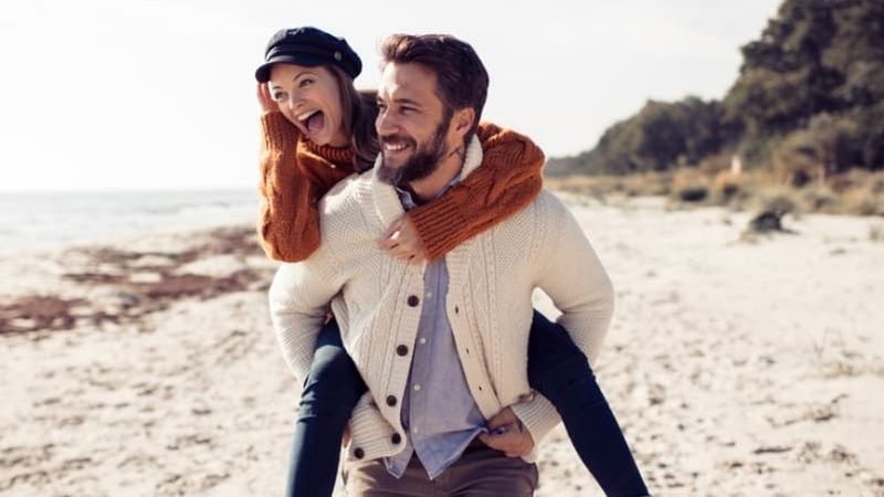 Couple Walking Along Beach